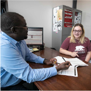 Students meeting with an instructor.