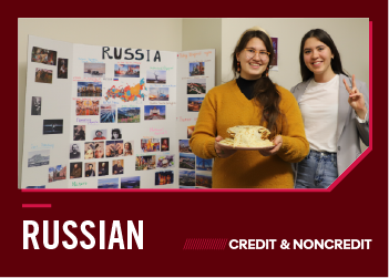 Two women presenting Russian culture at a display board.